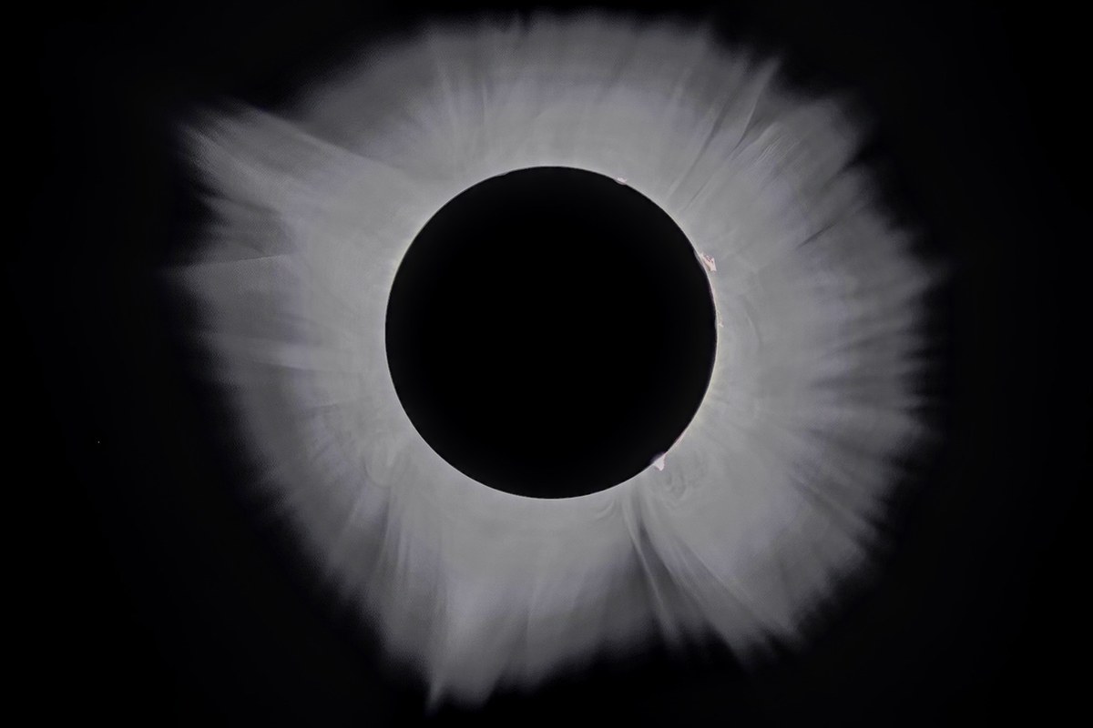 The Sun's corona fully surrounding the silhouette of the Moon during totality