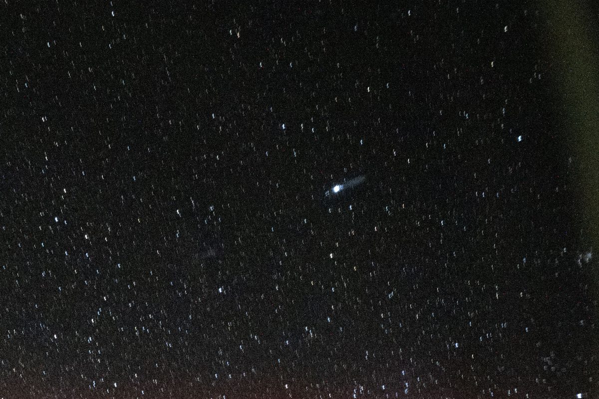 A mostly black night sky frame with only a scatter of faint pinpoint stars